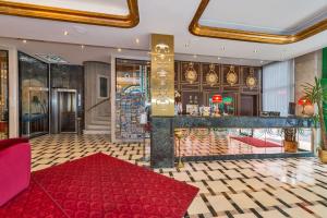 a lobby with a red rug and a bar at Green Anka Hotel in Istanbul