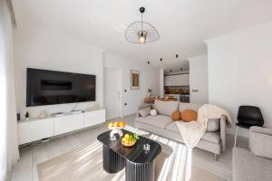 a living room with a couch and a table at Bodrum Center 2 Bedroom Calm Modern Garden Floor Flat - Yeni Dünya Bodrum in Bodrum City