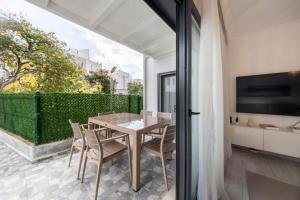 a dining room with a table and chairs at Bodrum Center 2 Bedroom Calm Modern Garden Floor Flat - Yeni Dünya Bodrum in Bodrum City +24 photos