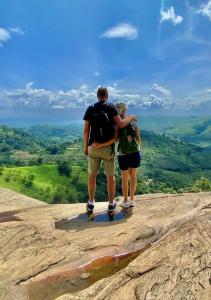 a man and woman standing on top of a mountain at Ella Retreat Glamping Tent on Hill for Nature Lovers in Ella