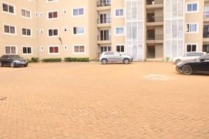 a parking lot with cars parked in front of a building at 3 bedroom furnished apartment at Kings Square in Eldoret