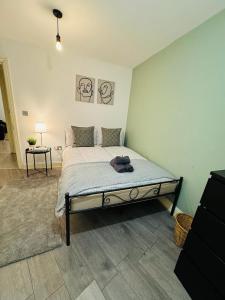 - une chambre avec un grand lit dans l'établissement Willesden J Guest Home 4, à Londres
