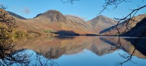 a view of a mountain reflecting in a lake at Wastwater Cottage on The Big "W" Ranch in Seascale