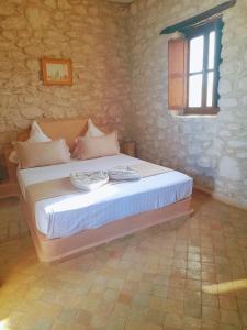 1 dormitorio con 1 cama con 2 almohadas en Riad Mamy Wababi en Essaouira