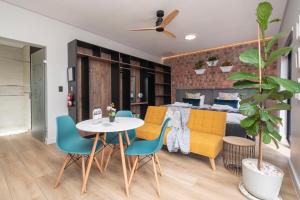 a living room with a table and chairs and a bed at Lemon Tree Studio 991 in Langebaan