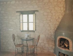 a table and chairs in a room with a fireplace at Riad Mamy Wababi in Essaouira