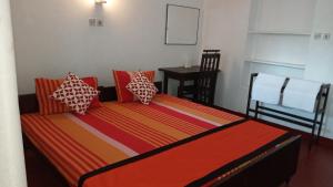 Postelja oz. postelje v sobi nastanitve New SeaSide Inn Hikkaduwa