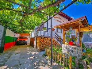 a building with a car parked in front of it at Guest House Dorkos in Dorkovo