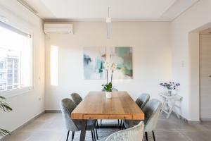 a dining room with a wooden table and chairs at Athens Acropolis Suite in Athens