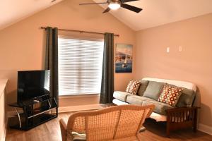 a living room with a couch and a tv at Spacious House near the Beach 300 in Myrtle Beach