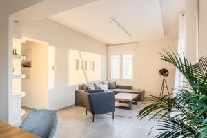 a living room with a couch and a table at Athens Acropolis Suite in Athens +28 photos