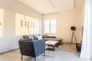 a living room with a couch and a table at Athens Acropolis Suite in Athens