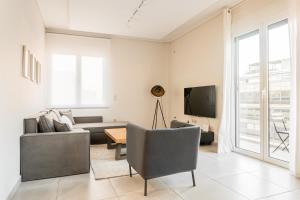 a living room with a couch and a tv at Athens Acropolis Suite in Athens