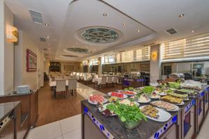 a buffet line with food on it in a restaurant at Green Anka Hotel in Istanbul