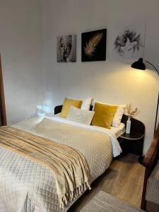 Un dormitorio con una cama grande con almohadas amarillas. en Cozy apartment near the Lviv National Opera, en Leópolis