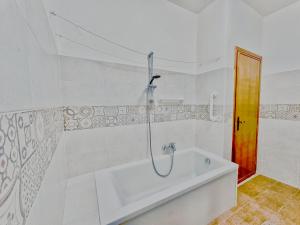 a bath tub in a bathroom with a shower at residenza piccolo diamante a 300m dal centro in Borno