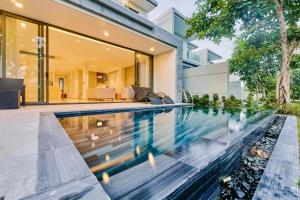 an infinity pool in the backyard of a house at "BRG GOLF CLUB" - Danang Private Pool Villa 3 Bedrooms #2 in Da Nang