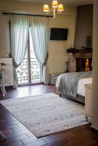 a bedroom with a bed and a fireplace at MARON ΙΙ με τζάκι in Kalavrita