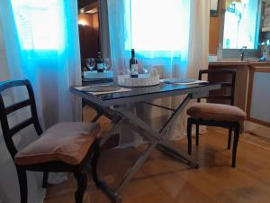 a table with two chairs and a bottle of wine at Arc de triomphe studio charme authentique in Paris