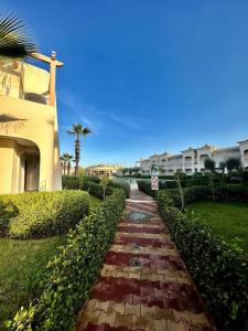 a brick walkway in front of a building at Oasis de Sérénité en Bord de Mer in Casablanca