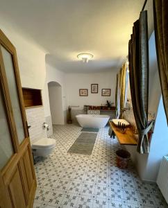 a bathroom with a tub and a toilet and a sink at Maison Český Krumlov in Český Krumlov