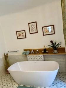 a large white bath tub in a bathroom at Maison Český Krumlov in Český Krumlov