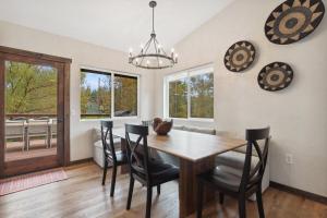 a dining room with a wooden table and chairs at Open Sky Retreat - Close to Trails, Private Hot Tub, Big Yard, & Kid Friendly in Whitefish