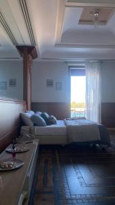 a bedroom with a large bed and a window at Regina del Porto in Brindisi