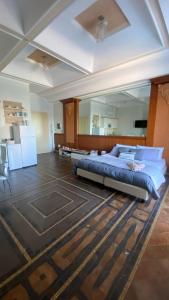 a bedroom with a bed and a large mirror at Regina del Porto in Brindisi