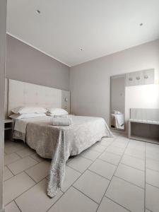 a white bedroom with a bed and a tiled floor at Hotel Stefan Room & Breakfast in Gatteo a Mare +71 photos