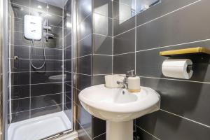 a small bathroom with a sink and a shower at Next to station/stadium/the city in Liverpool