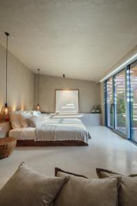 a large bedroom with a large bed and windows at Roome in Fethiye