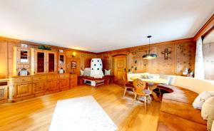 a living room with wooden walls and a table and chairs at Ferienhaus Hennewinkl in Oetz