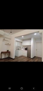 a large kitchen with white cabinets and a table at MAIN PLACE USJ21 SUBANG JAYA in Subang Jaya
