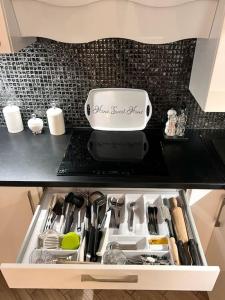 a kitchen counter with a drawer full of kitchen utensils at Apartament Zamojski Młyńska in Zamość