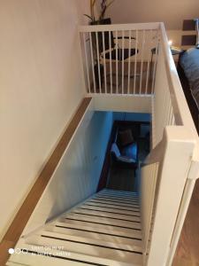 a room with a staircase with a bed in it at Appartement Ruinerwold in Ruinerwold