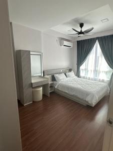 a bedroom with a bed and a ceiling fan at Sri Indah condominium in Sandakan +15 photos