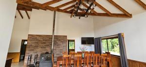 a dining room with a table and chairs and a fireplace at Casa de campo Villarrica in Villarrica