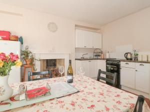 a kitchen with a table with a bottle of wine at Wards Court 2 in Gloucester