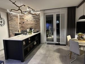 a kitchen and dining room with a christmas tree at Apartament Premium Moszna in Moszna