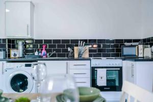 a kitchen with a dishwasher and a washer and dryer at Spacious One-Bedroom Apartment in Saint Helens in Saint Helens