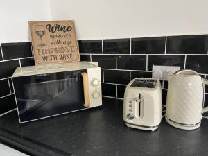 a counter top with a toaster and a toaster and a toaster at Spacious One-Bedroom Apartment in Saint Helens in Saint Helens