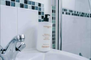 a bottle of moisturizing soap sitting on a bathroom sink at Spacious One-Bedroom Apartment in Saint Helens in Saint Helens