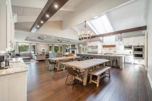 an open kitchen and living room with wooden tables at Stunning Luxury Lakefront Lodge! 8 BRs! Sleeps 32! in Hot Springs