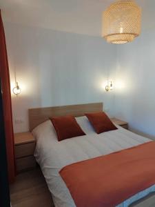a bedroom with a bed with two pillows on it at Appartement moderne refait à neuf - 4 couchages - MENTON in Menton