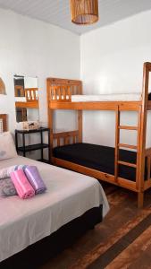 a bedroom with two bunk beds and a mirror at Pousada Suítes Sete Mares in Guarujá