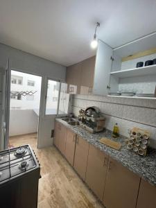 uma cozinha com um fogão e uma bancada em Cosy & spacious apartment em Temara