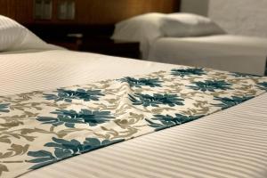 Voodi või voodid majutusasutuse Hotel Puerta Chichen toas