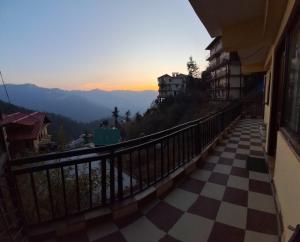 a view from the balcony of a building with a checkered floor at Anand Niketan Homestay Shimla in Shimla
