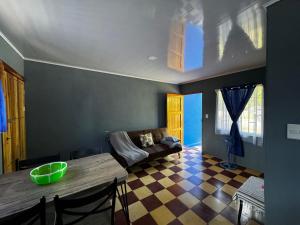 a living room with a table and a couch at Estudio Mar Azul in Puntarenas